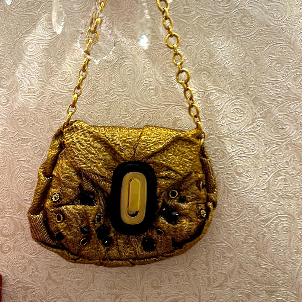 Dolce Gabbana small gold bag on a gold chain.